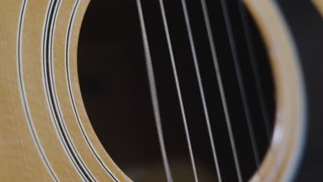 extreme slo mo clip over the sound hole of an old acoustic