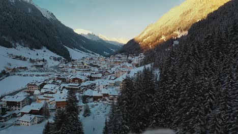 beautiful ski resort village in austrian alps mountain valley, winter aerial