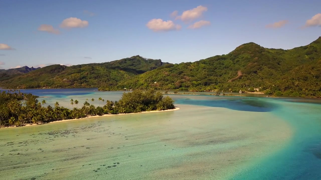 Luftfoto fra drone af Fransk Polynesien, der viser turkise lagunevande, hvide sandstrande og frodige palmeskove mod grønne vulkanske bjerge. Øerne Bora Bora, Huahine, Tahiti, Rangiroa.