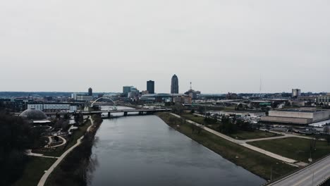 drone shot of the des moines river passing through the downtown area of iowa's capitol