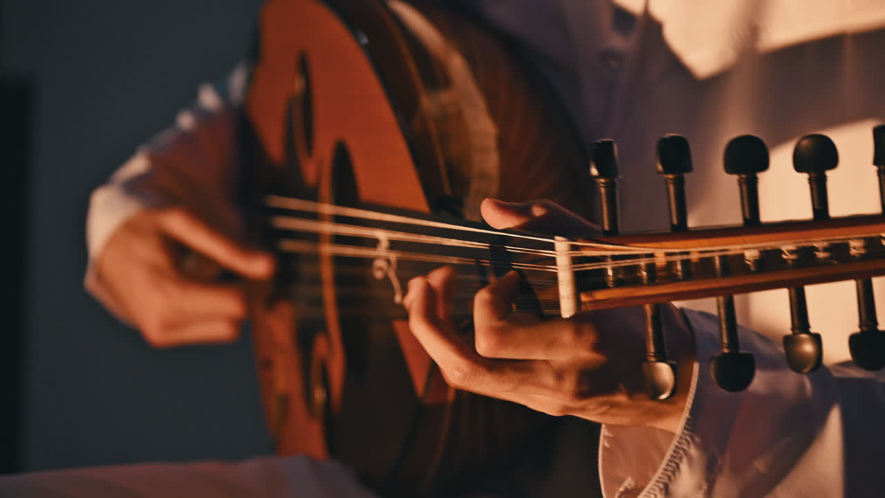 An Arab musician plays the oud, a beloved traditional string instrument in Arabic music