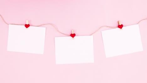 papers hooking on rope with hearts for valentine day. stop motion