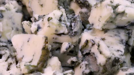 macro shot of roquefort cheese chopped in small pieces