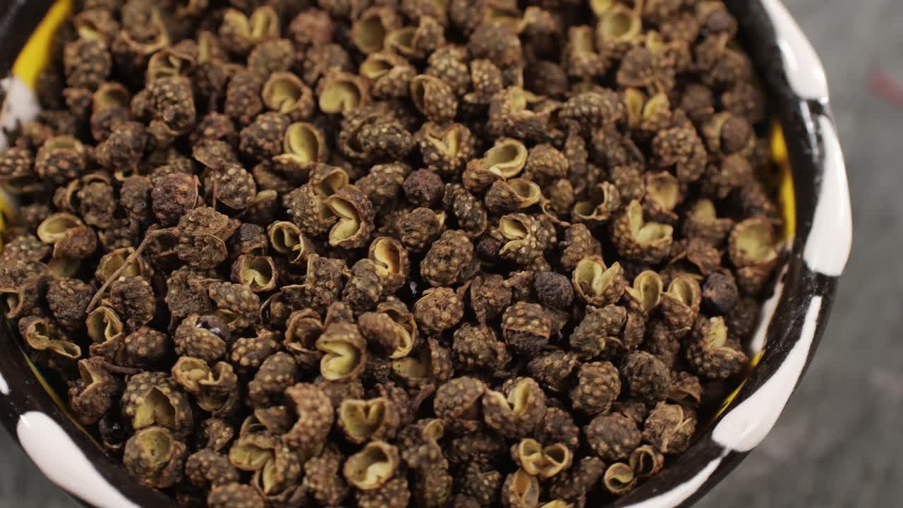 Dried black pepper rotating top view. A bunch of natural black pepper peas hot spice.Seasonings and condiments concept