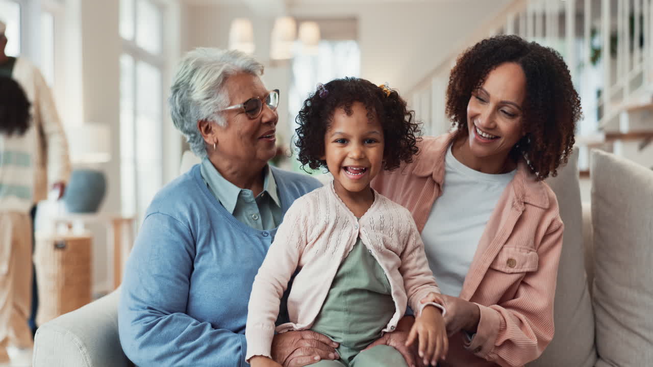 Three generations of a family smiling and laughing together in a living room