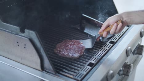 cooking a hamburger on a grill