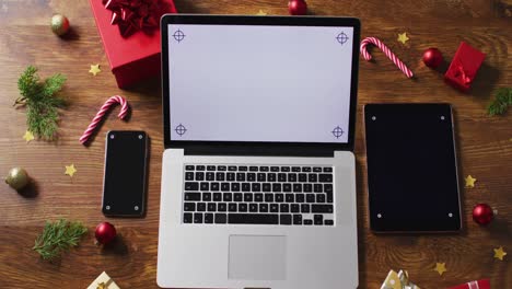 video of christmas decorations with laptop and copy space on wooden table