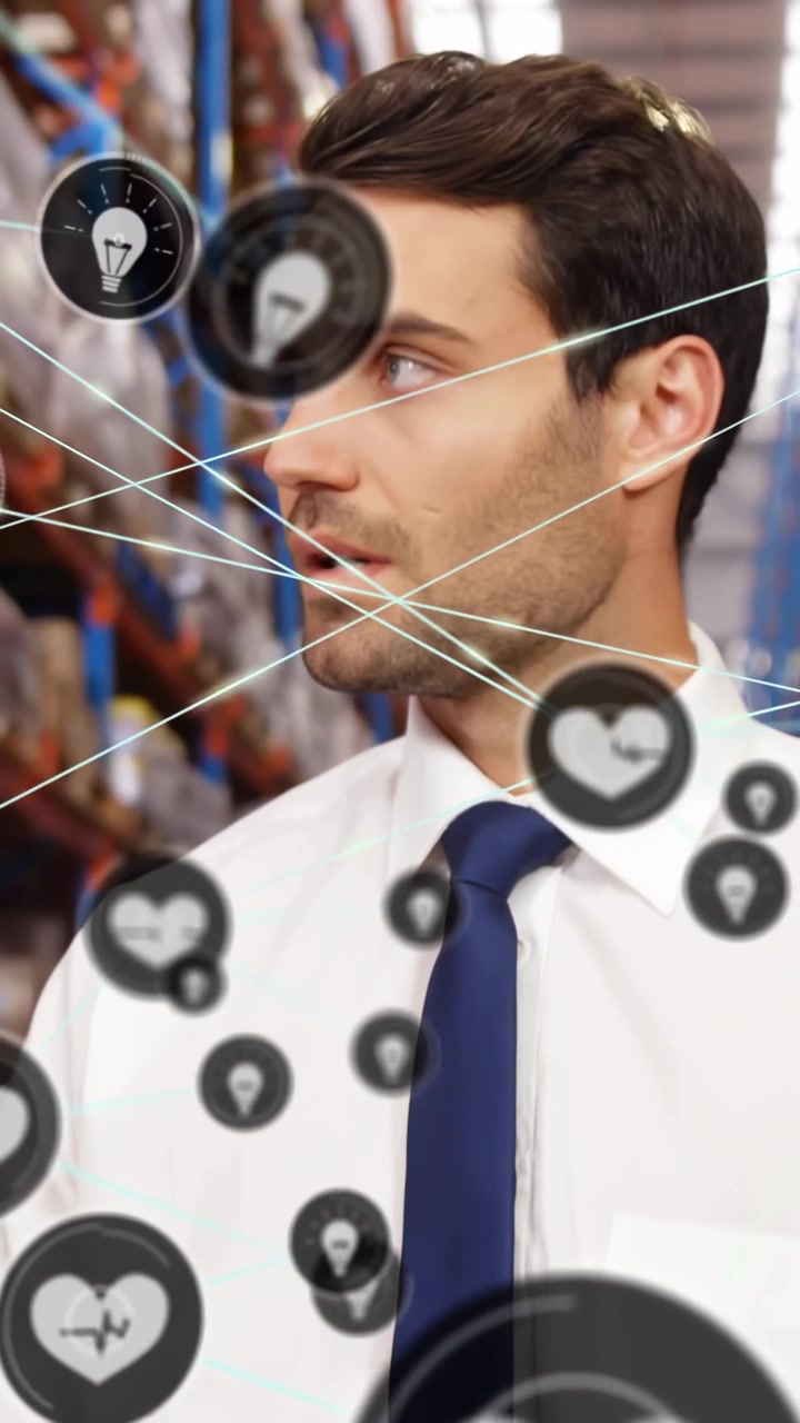 Vertical video: Man reading tablet in depot, heart icon and markers overlaying while checking stock