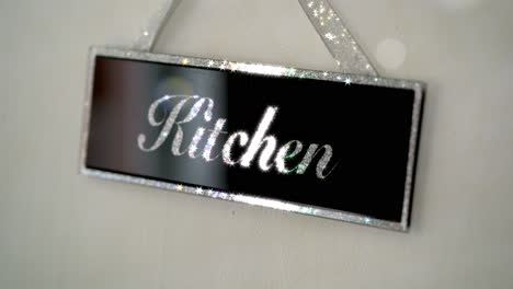 kitchen sign black and sliver on wall sparkling