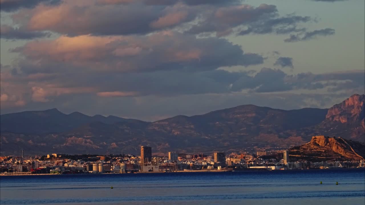 City Skyline at Sunset with Mountains in Background