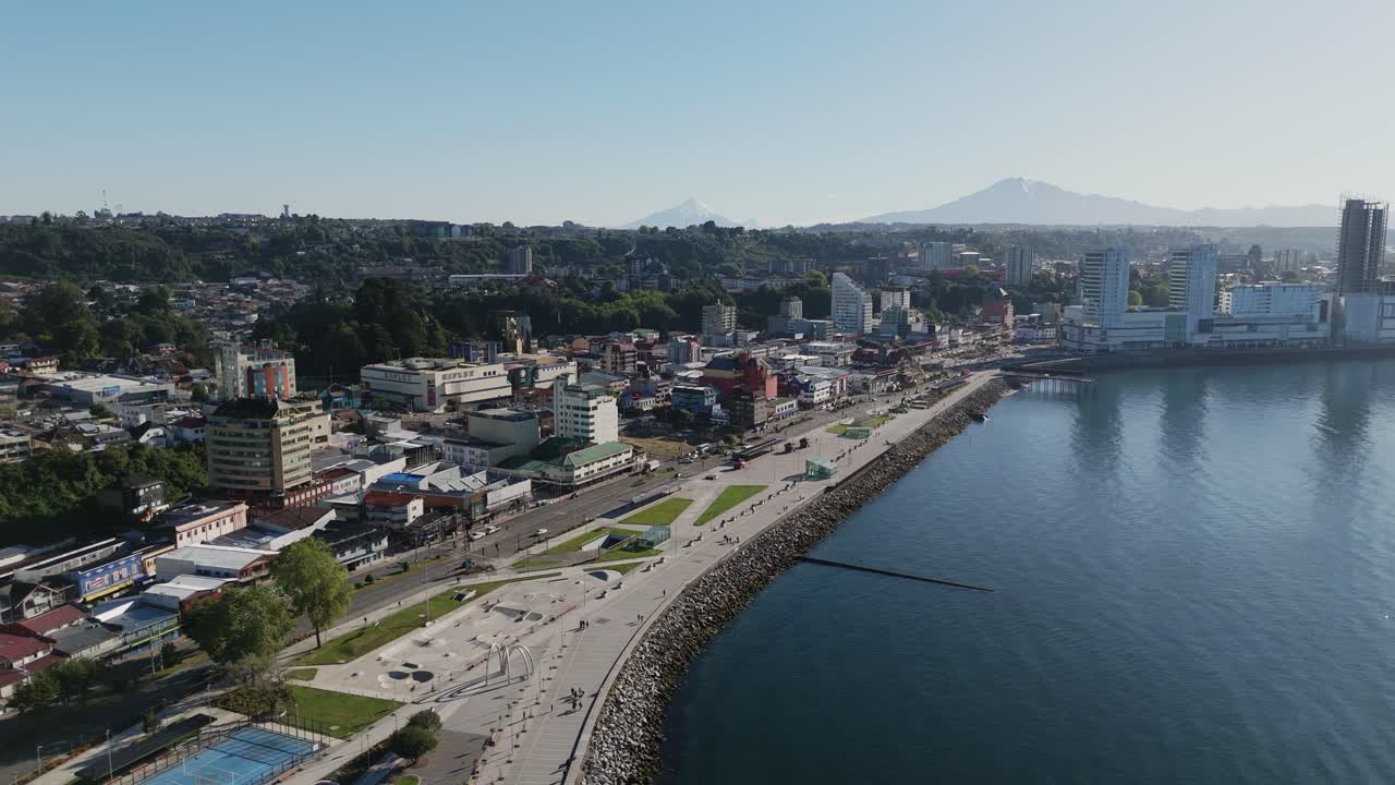 Aerial cityscape of Puerto Montt, featuring the Diego Portales waterfront, modern buildings, and the scenic Reloncavi Sound in Los Lagos, Chile.orbit motion