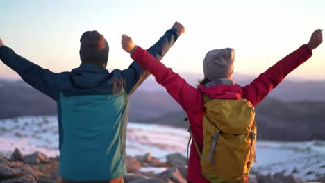 joyful adventurers celebrate a stunning mountain sunrise with open arms, embracing nature's beauty and cherishing the moment of triumph over their journey