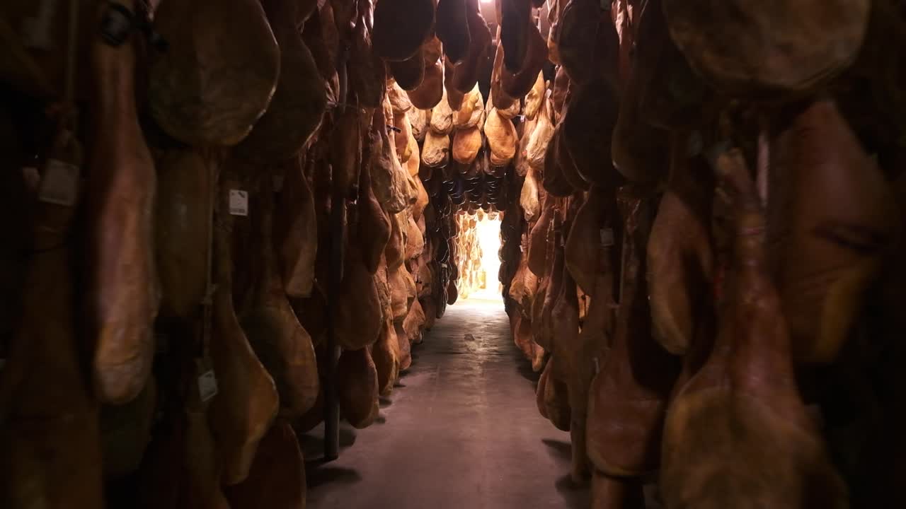 Jamon serrano pig legs factory hanging in a industry. Iberian ham elaboration process