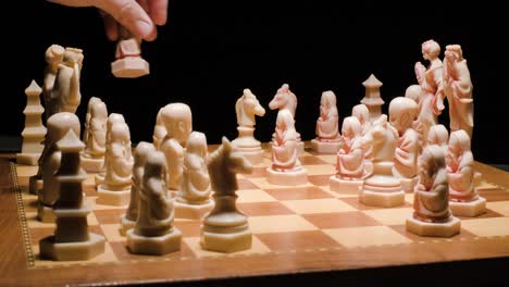 playing chess, conceptual chessboard and pieces, hand move horse