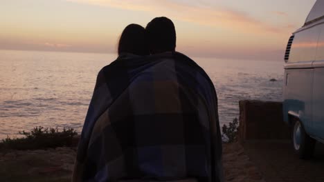 young couple enjoying the sunset view