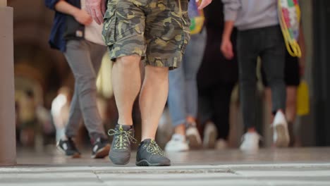 passing pedestrians waist down in low angle slow motion shot