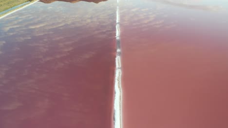 aerial view of pink ponds water and sky mirror reflection