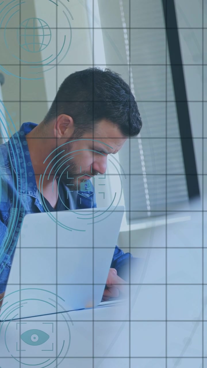 Vertical video: Man reacting to HUD appearing, leaning in and typing on laptop, reviewing data