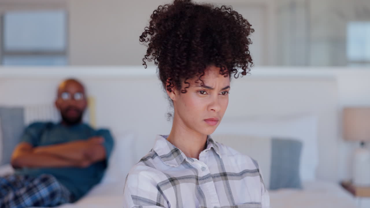 Woman, angry and conflict with partner in bedroom