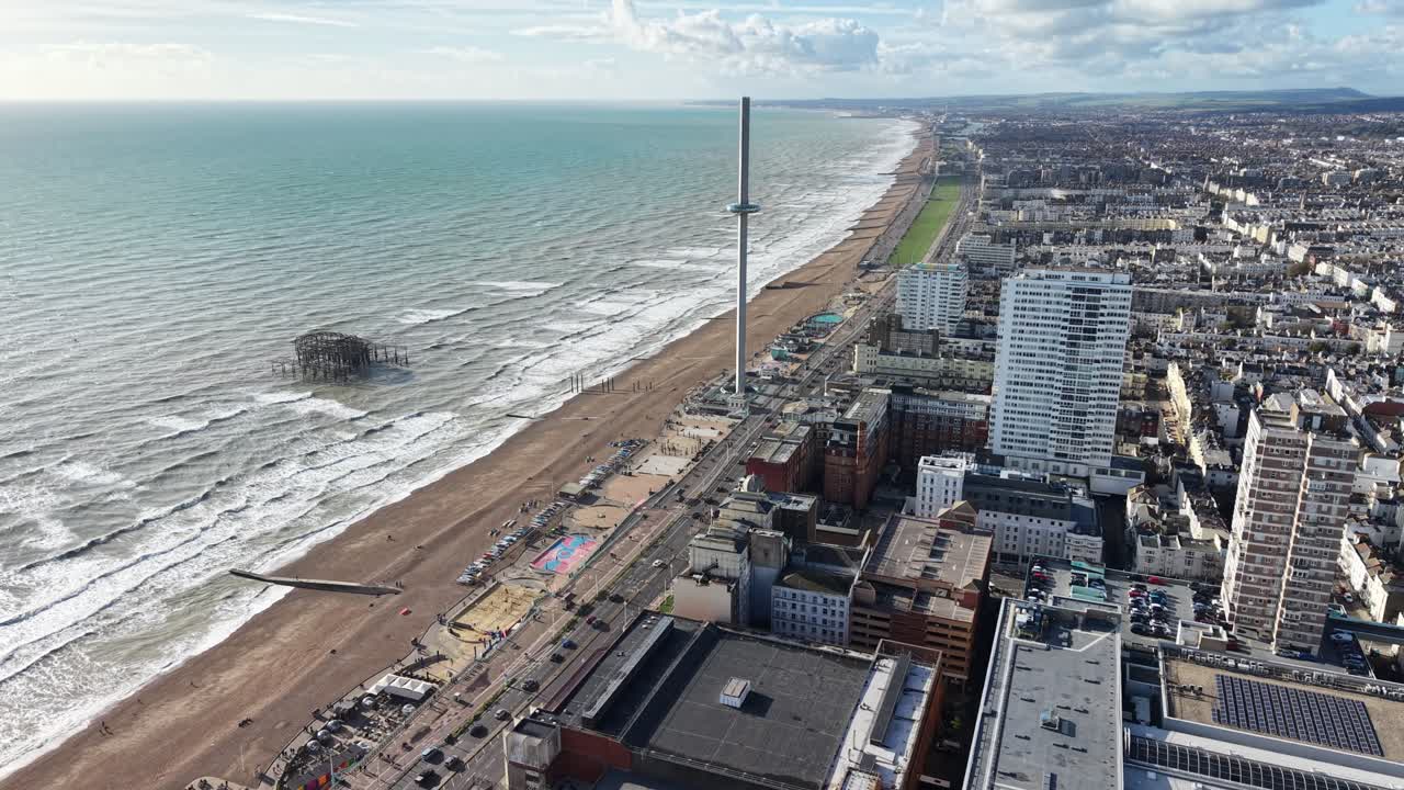 Panning drone aerial Brighton Beach UK high angle shot sunny day