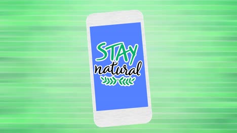 animation of stay natural text and leaf logo on blue smartphone screen, on green background