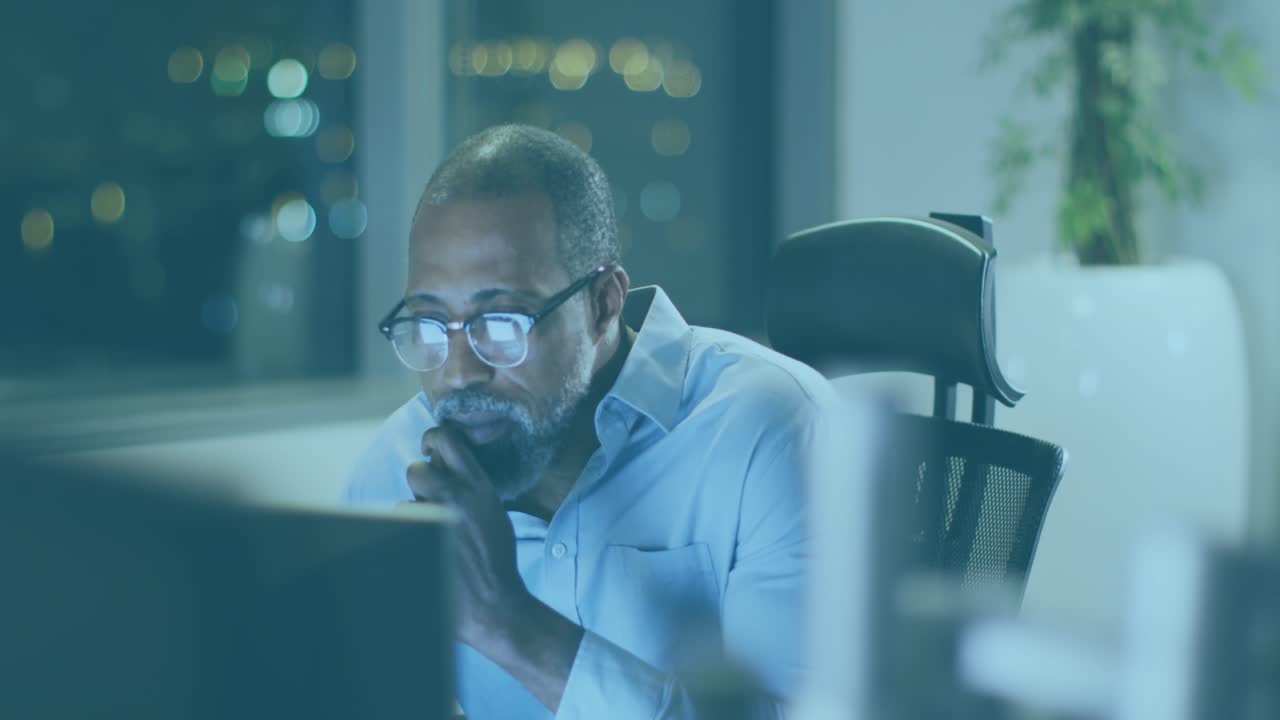 Animation of data processing over african american businessman using laptop