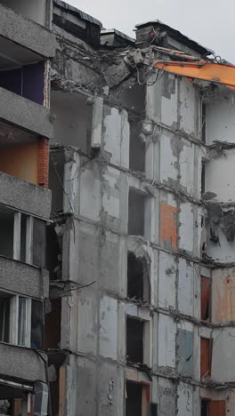 destruction excavator house demolishing. demolition building by machine. vertical video