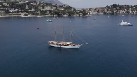 Barque-Luxury-Sailing-Yacht-with-Three-Masts-on-Mediterranean-Coastline,-Aerial