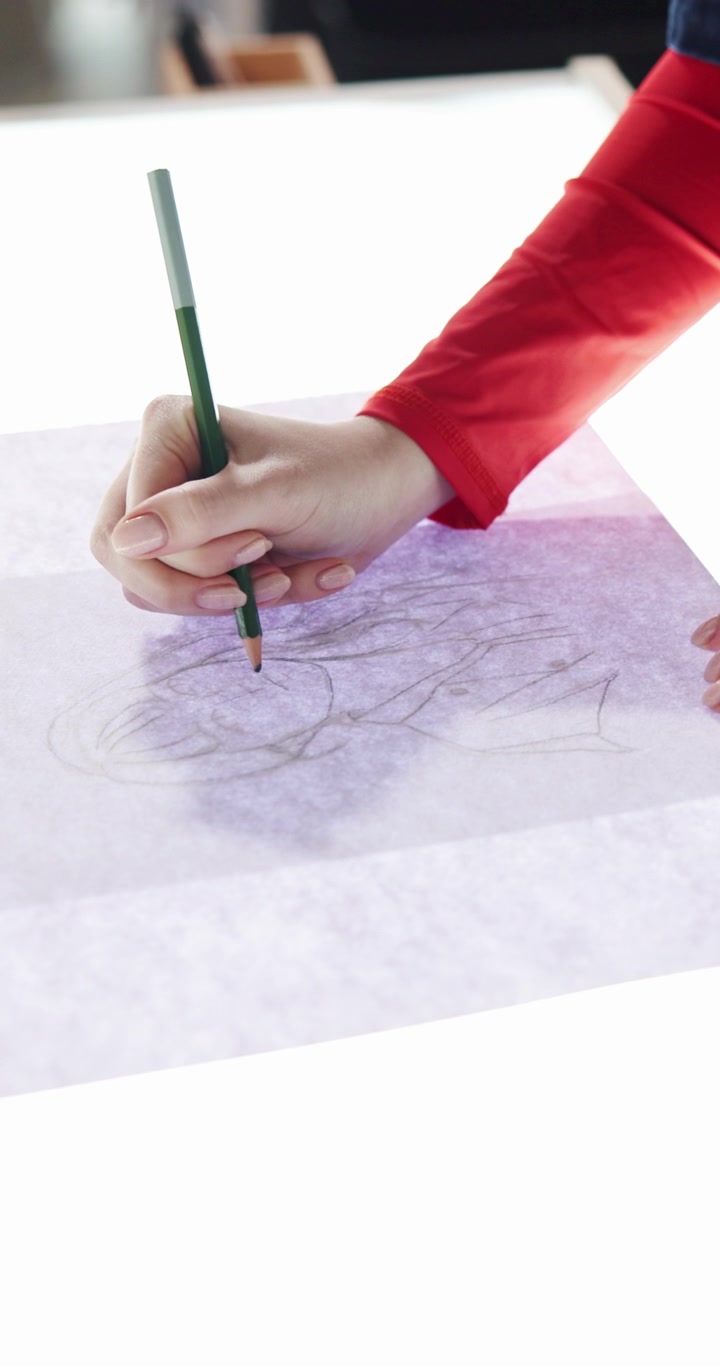 Artist Sketching a Portrait on Tracing Paper