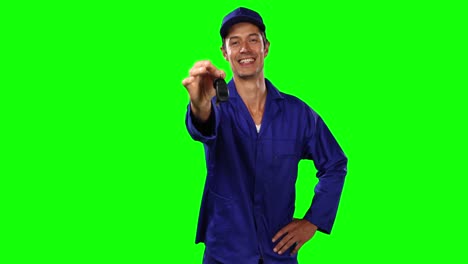 Front-view-of-mechanic-giving-car-keys-with-green-screen