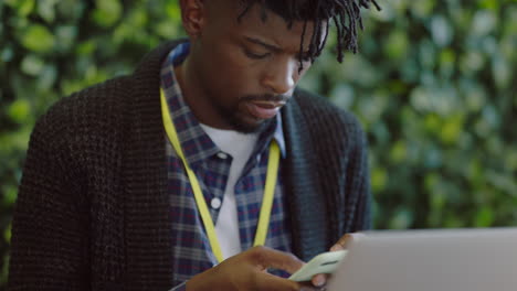 young african american businessman using smartphone texting online social media messaging on mobile phone sharing digital connection in modern office