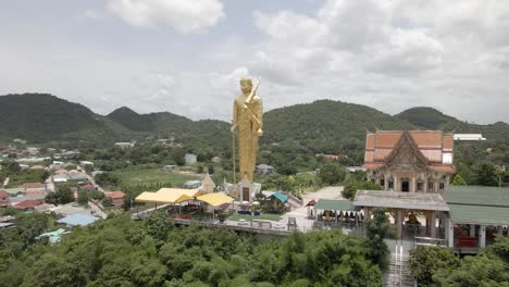 scenic landscape of giant golden buddha standing on wat khao noi temple, hua hin