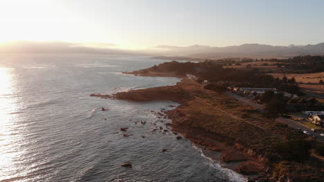 drone ascends over pacific coast highway at golden hour