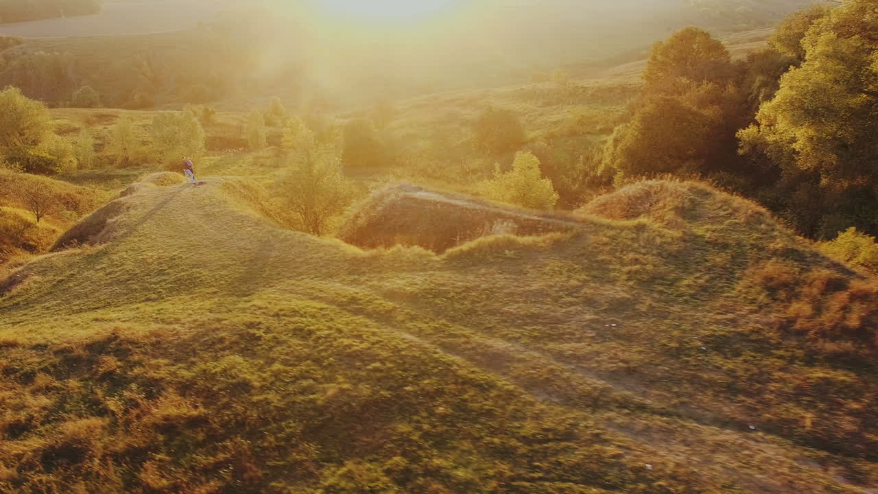 Couple In Love Against A Beautiful Sunset. Aerial shot of a couple in love against the backdrop of a beautiful sunset