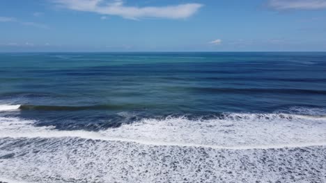 drone view of beautiful seamless never ending footage while turquiose sea waves breaking on sandy coastline