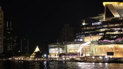 nighttime city lights with boat crossing water