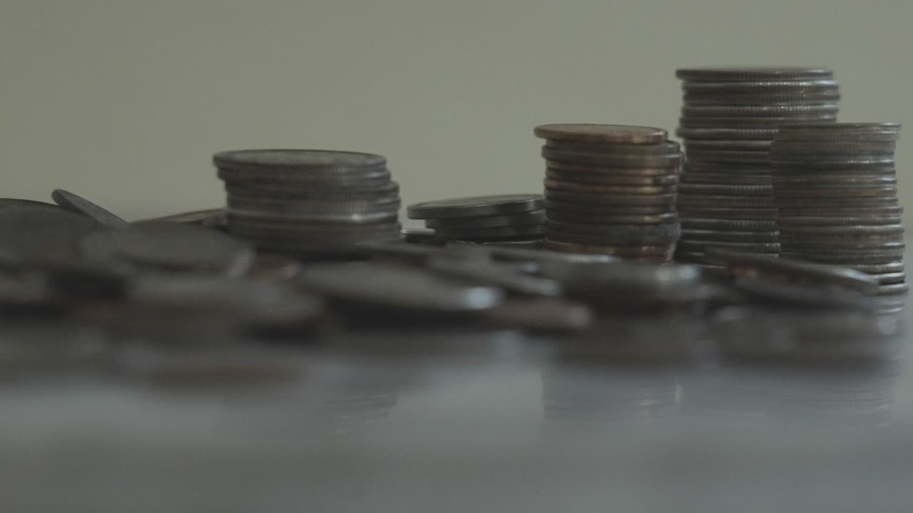 Varied stacks of coins near a pile