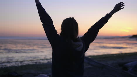 rack focus girl stretch the arms on the beach during the sunset richmond