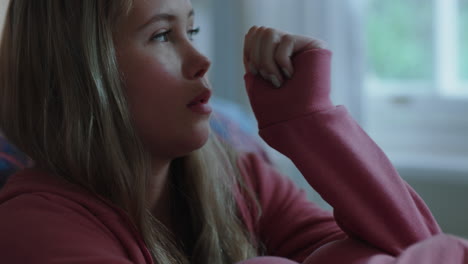 sad teenage girl alone at home feeling depressed moody teen thinking of emotional break up sitting in bedroom