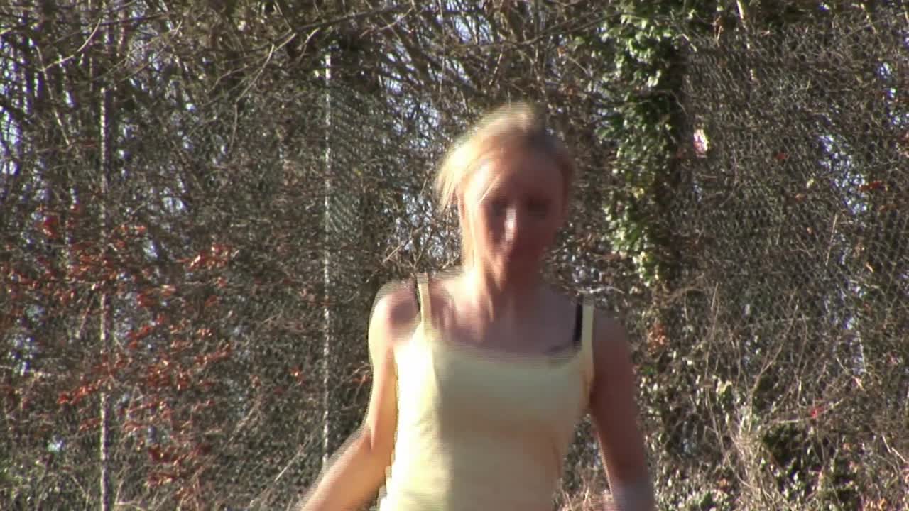 Woman running at track and field competition