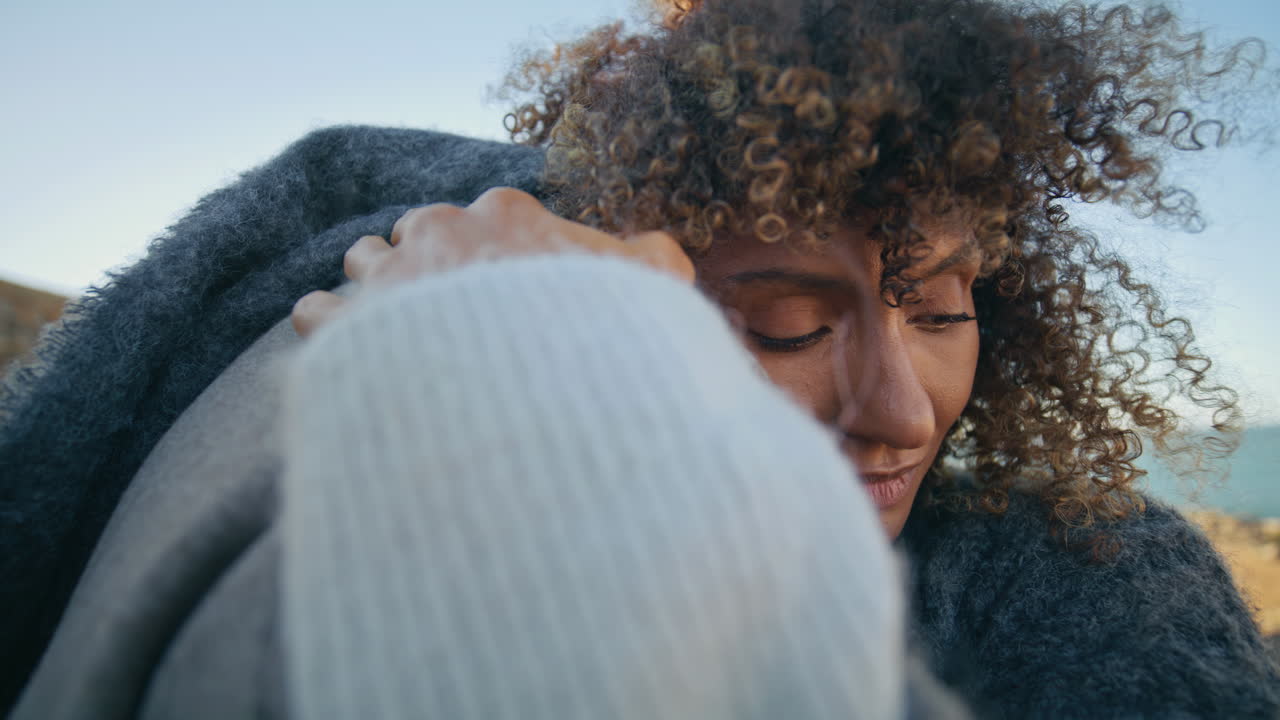 Closeup curly woman hugging man on marine nature. Happy couple romantic date