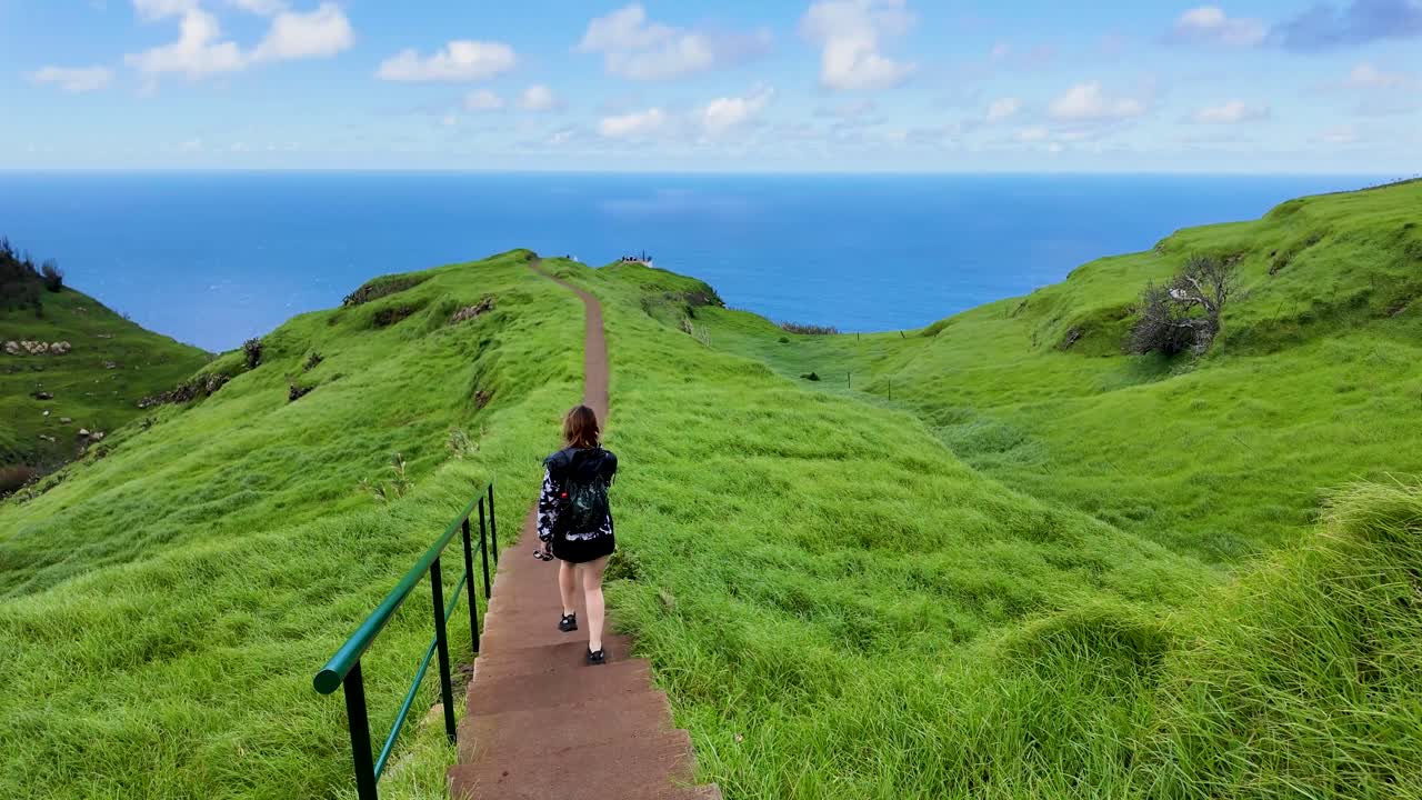 Girl Walking Along Clifftop Path with Tall Green Grass at Ponta do Pargo, Boa Morte, Madeira