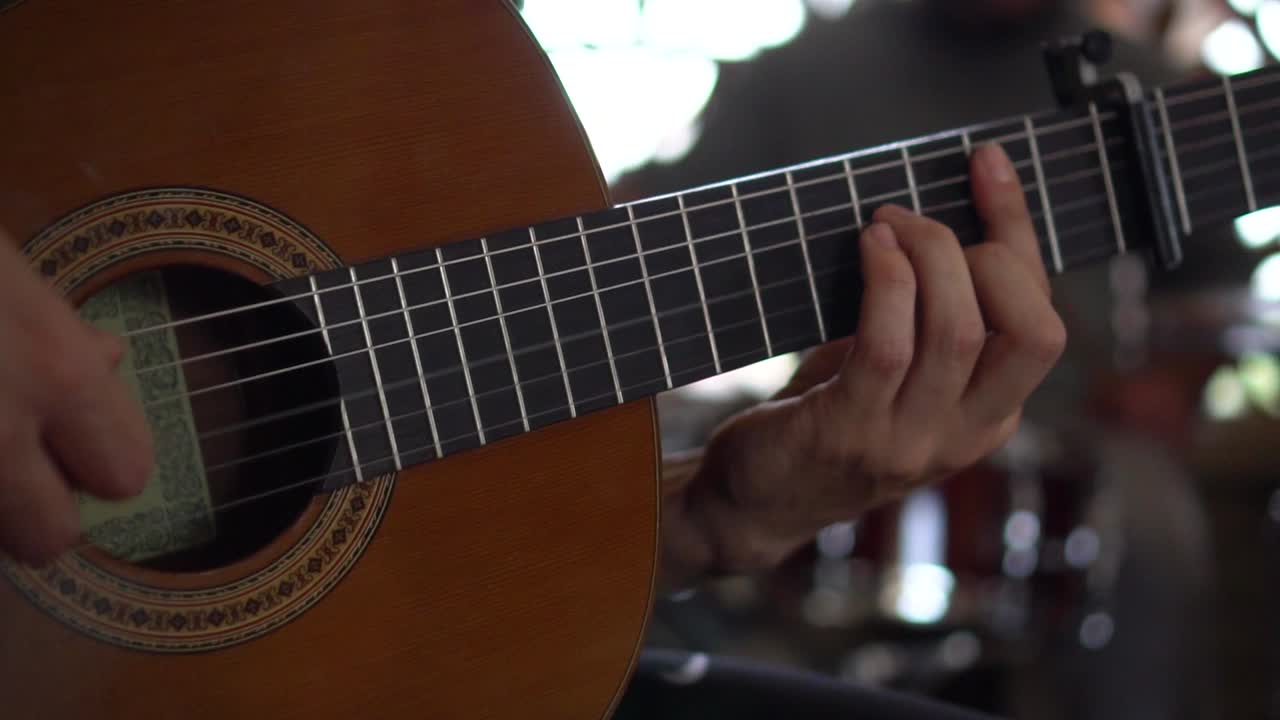 Guitarist playing a classical guitar in slow motion. Musician playing guitar. Guitar player.