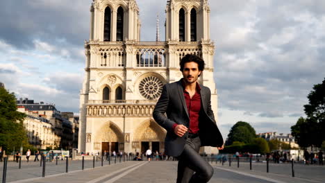 stylish man posing in front of notre dame cathedral in paris