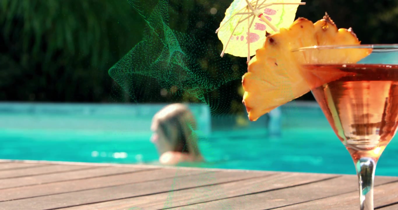 Green wave drifting across pool, woman swimming behind it past cocktail glass in beverage marketing