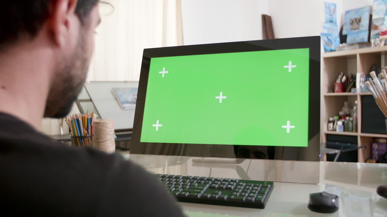 Person using computer with green screen