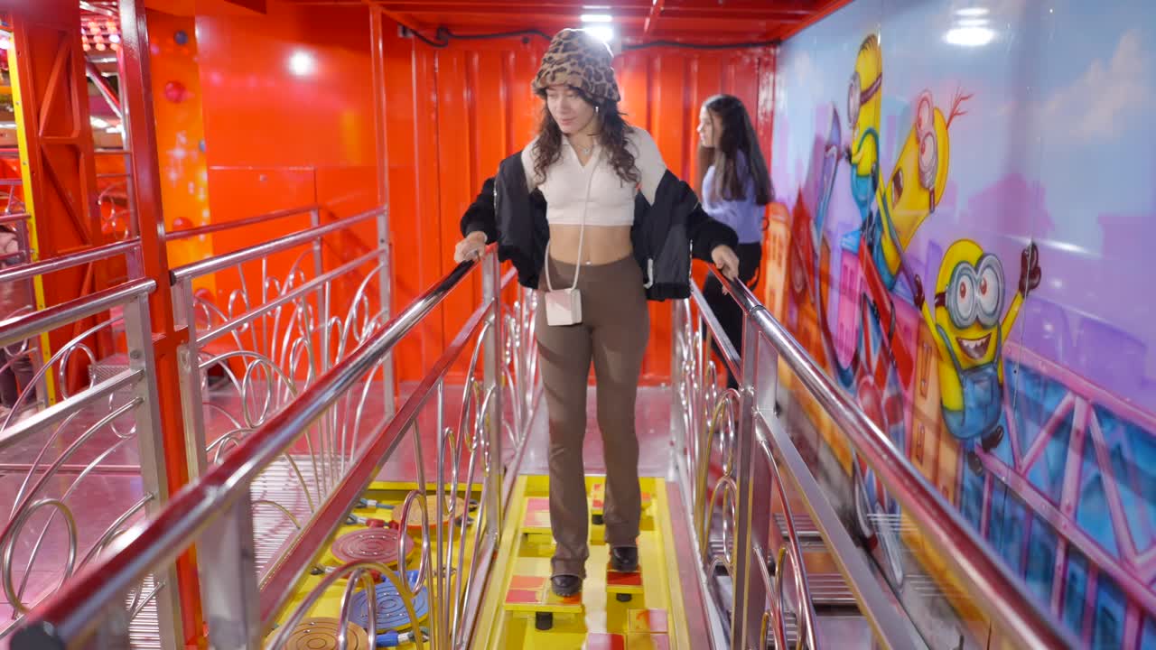 Woman walking on an amusement park game platform