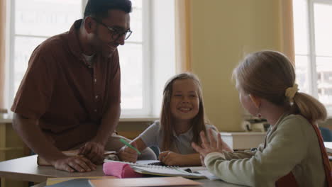 teacher interacting with students in classroom