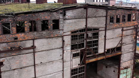abandoned building during war time. destroyed building with broken windows. exterior of ruined architecture.