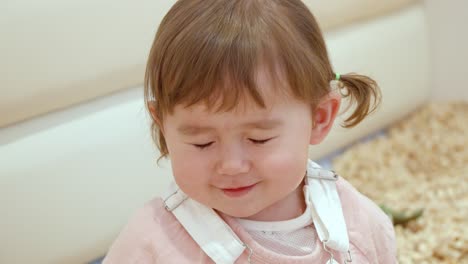 charming and lovely face of a little girl smiling in front of camera